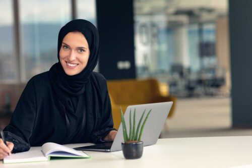 professional young muslim business woman using mobile digital tablet computer at work