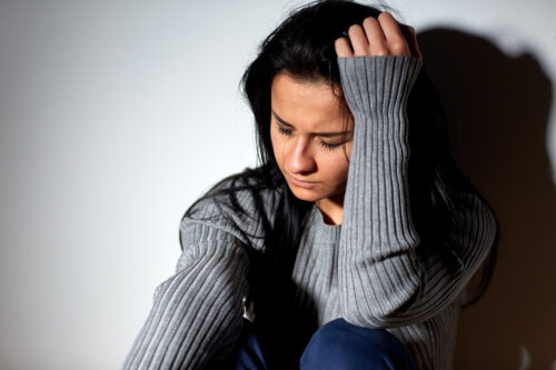unhappy woman crying on floor