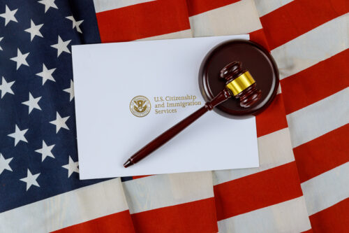Judge's gavel, lawyers office deportation U.S. Citizenship and Immigration Services of naturalization with USA flag