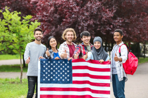 Group of students with USA flag outdoors