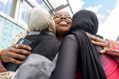 Young women hugging